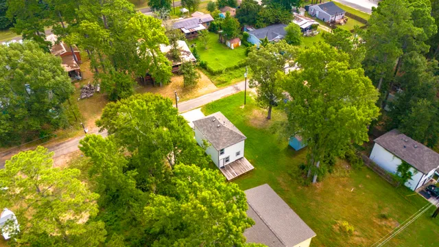 an aerial view of a house with swimming pool and garden