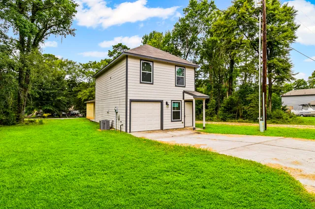 a view of a house with a yard and sitting area