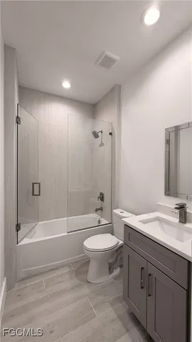 a bathroom with a double vanity sink toilet mirror and bathtub