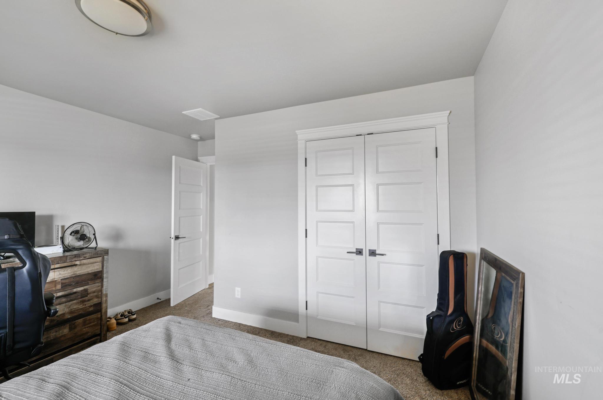 1150 Kimberly Meadows Road Kimberly, ID 83341 - Photo 11 of 32 Bedroom featuring light gray walls, carpeted flooring, and a flush-mount ceiling light fixture