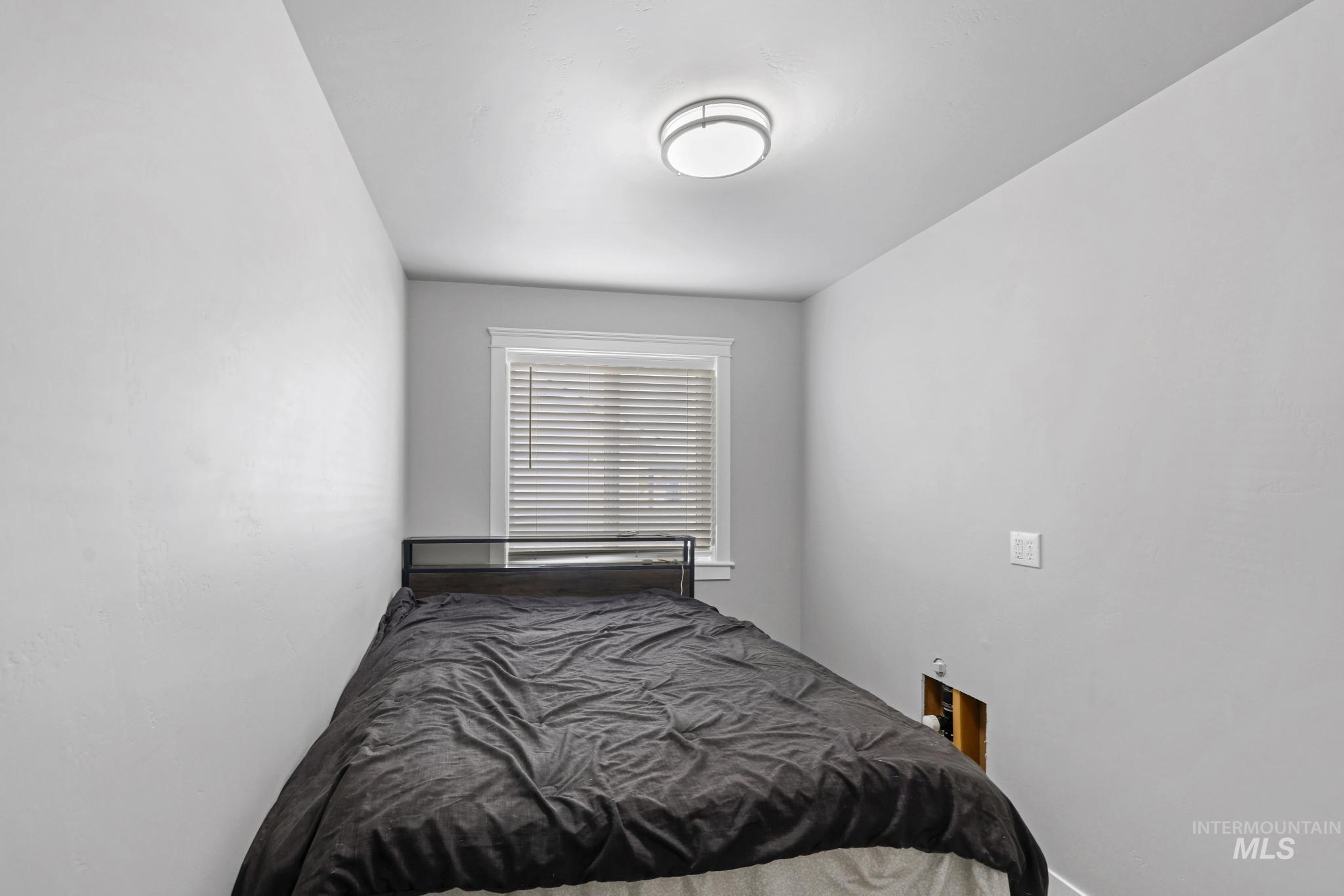 1150 Kimberly Meadows Road Kimberly, ID 83341 - Photo 14 of 32 Compact room featuring a window with blinds, overhead flush-mount lighting, and light-colored walls