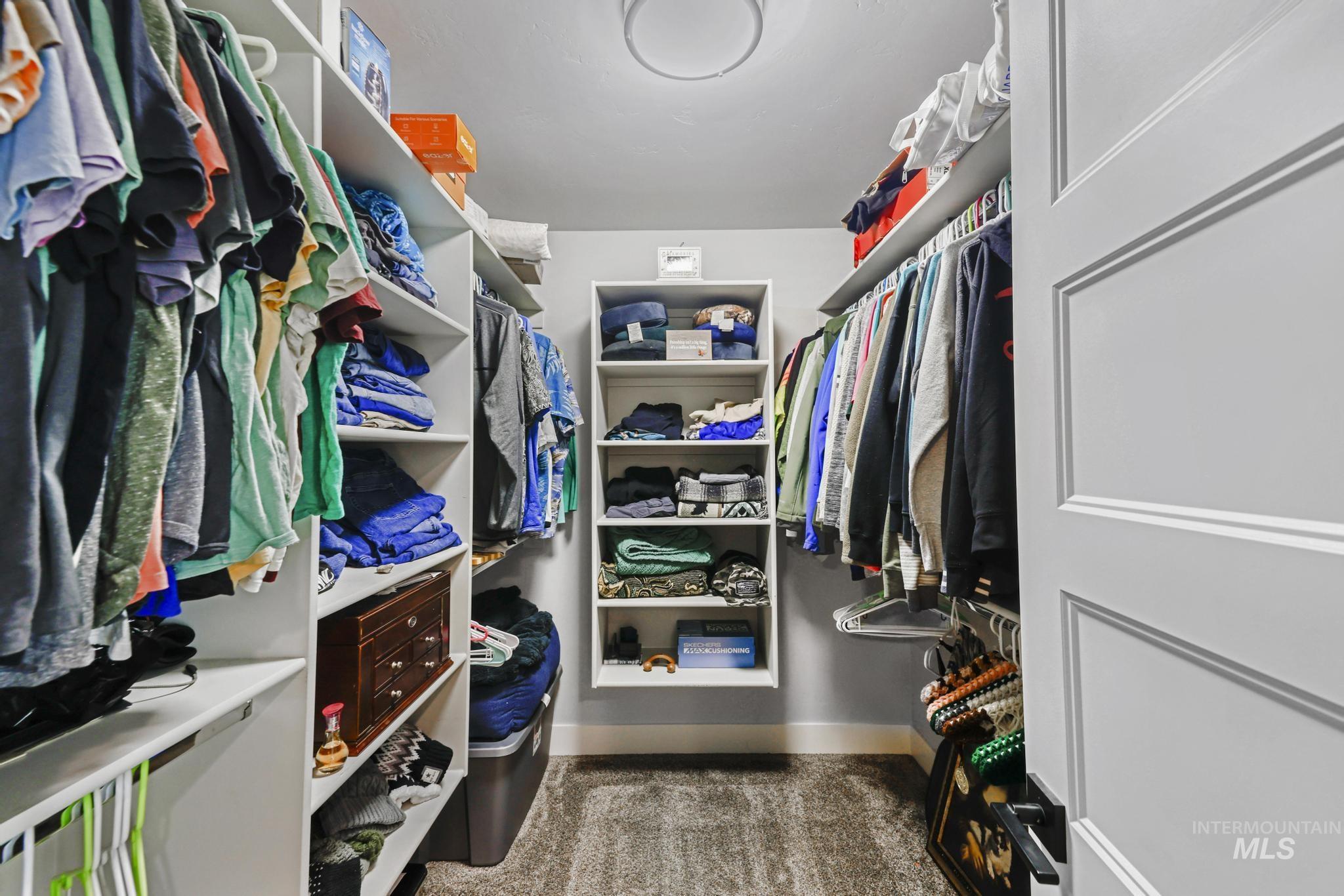 1150 Kimberly Meadows Road Kimberly, ID 83341 - Photo 16 of 32 Walk-in closet featuring built-in shelving, hanging rods, and carpet flooring