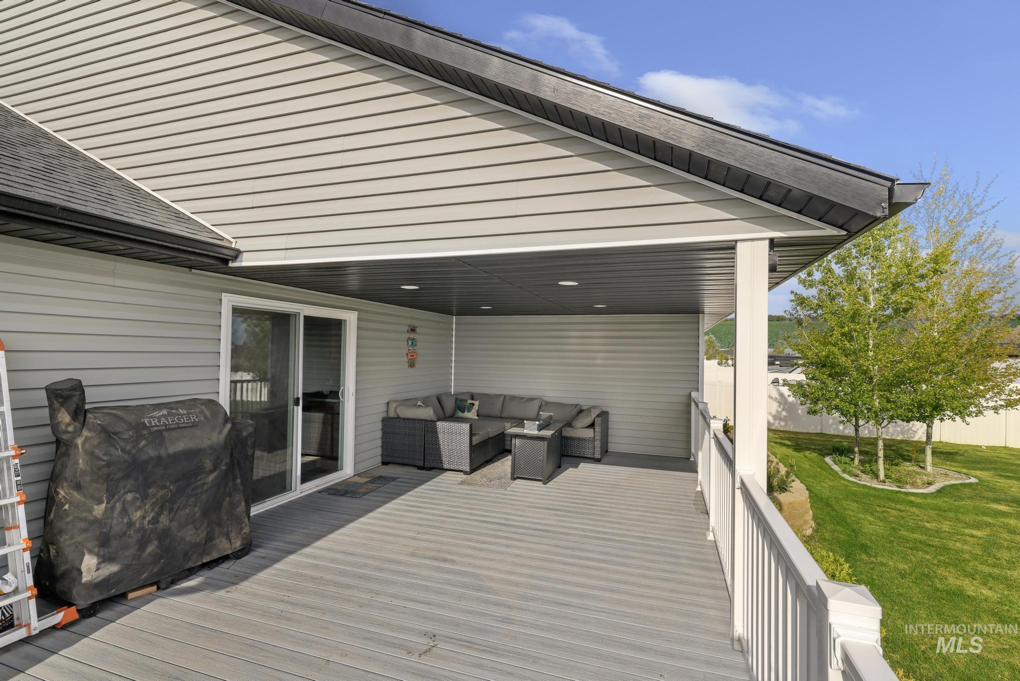1150 Kimberly Meadows Road Kimberly, ID 83341 - Photo 24 of 32 Expansive covered deck with composite flooring, white railing, and soffit lighting