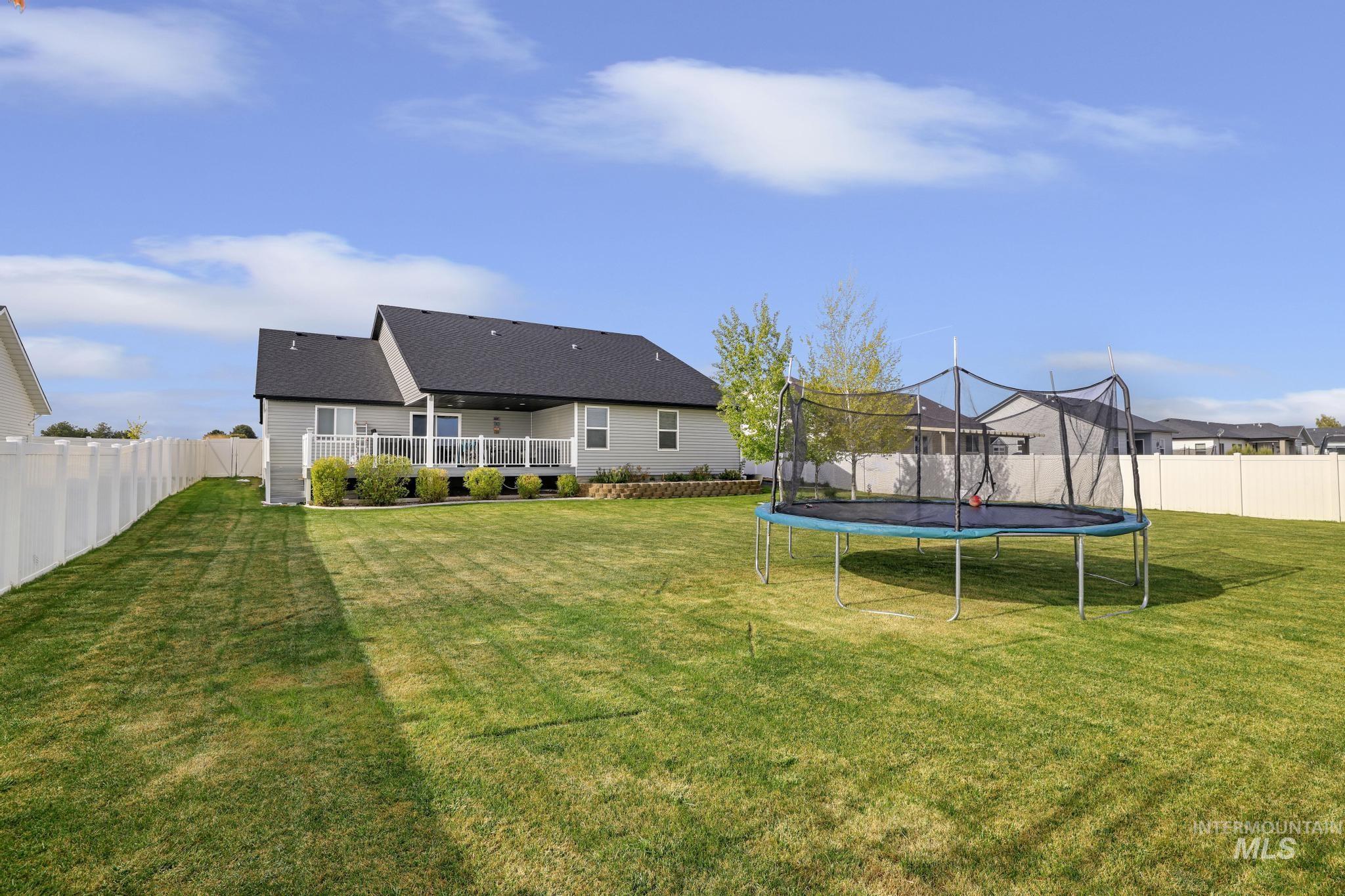 1150 Kimberly Meadows Road Kimberly, ID 83341 - Photo 25 of 32 Expansive green lawn with a white privacy fence
