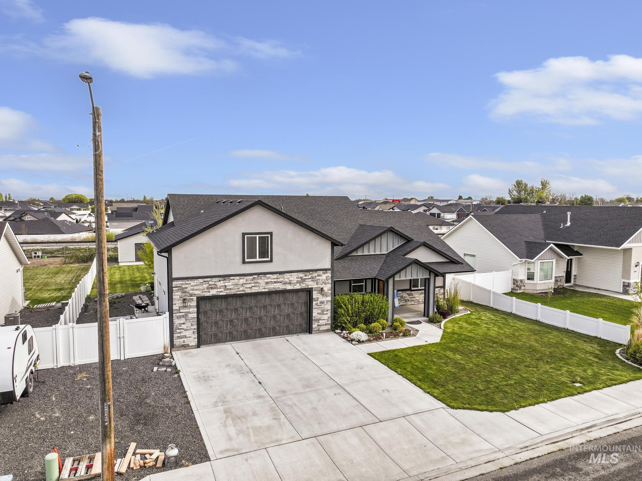1150 Kimberly Meadows Road Kimberly, ID 83341 - Photo 3 of 32 Contemporary two-story residence featuring a gray exterior with stone accents and a prominent two-car garage