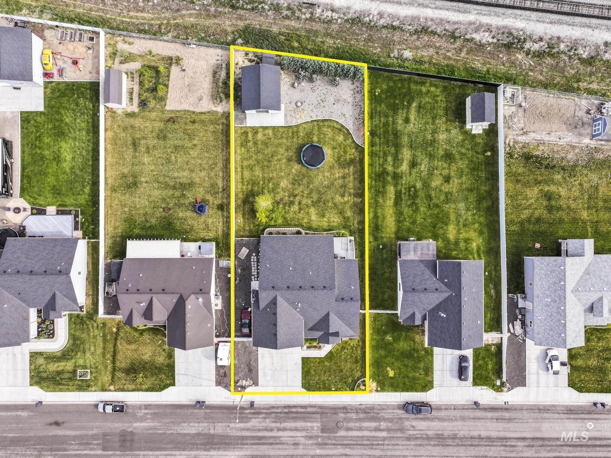 1150 Kimberly Meadows Road Kimberly, ID 83341 - Photo 31 of 32 Two-story residence featuring a dark shingle roof, concrete driveway, and a spacious rear yard with green lawn
