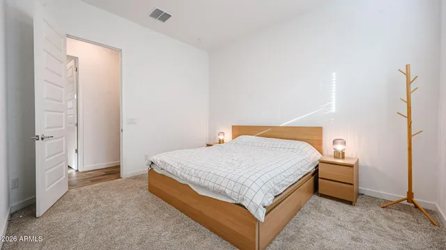 a bedroom with a bed and a table