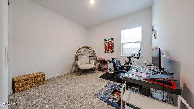 a view of a workspace with furniture and a window
