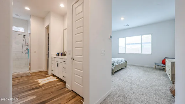 a spacious bathroom with a shower sink and mirror
