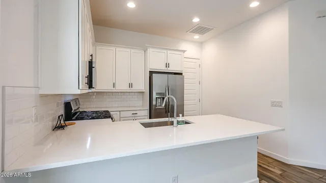 a kitchen with a sink cabinets and appliances