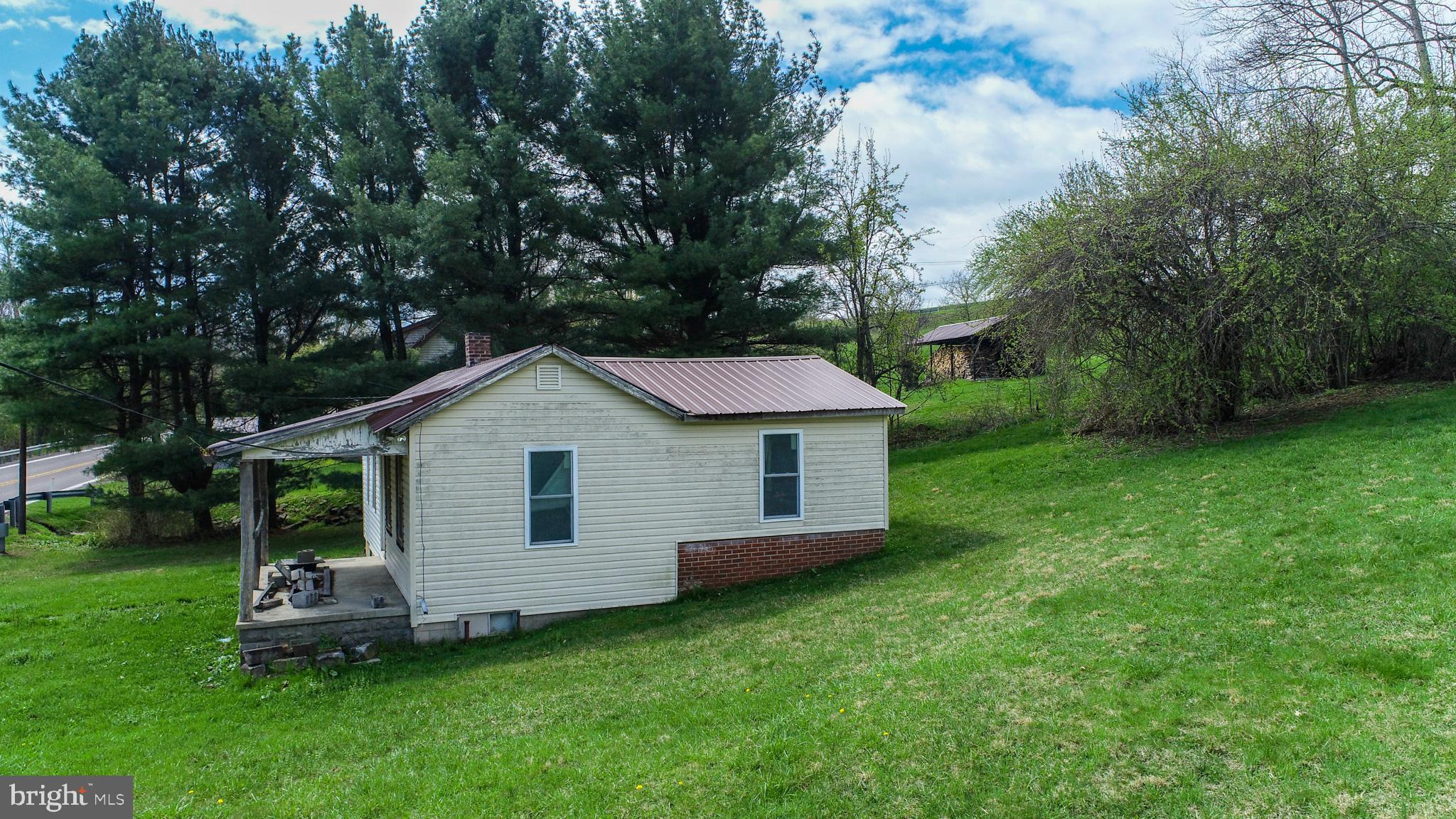 10785 Friendsville Road Friendsville, MD 21531 - Photo 6 of 19 a front view of a house with a garden