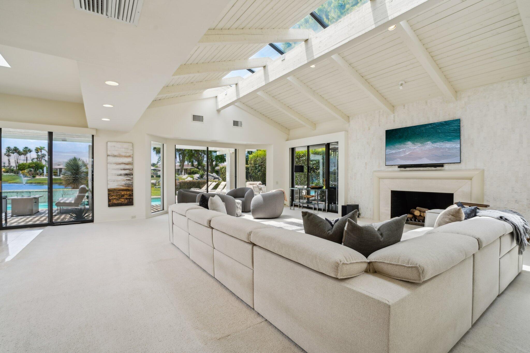 23 Park Lane Rancho Mirage, CA 92270 - Photo 13 of 57 a living room with furniture a large window and a fireplace