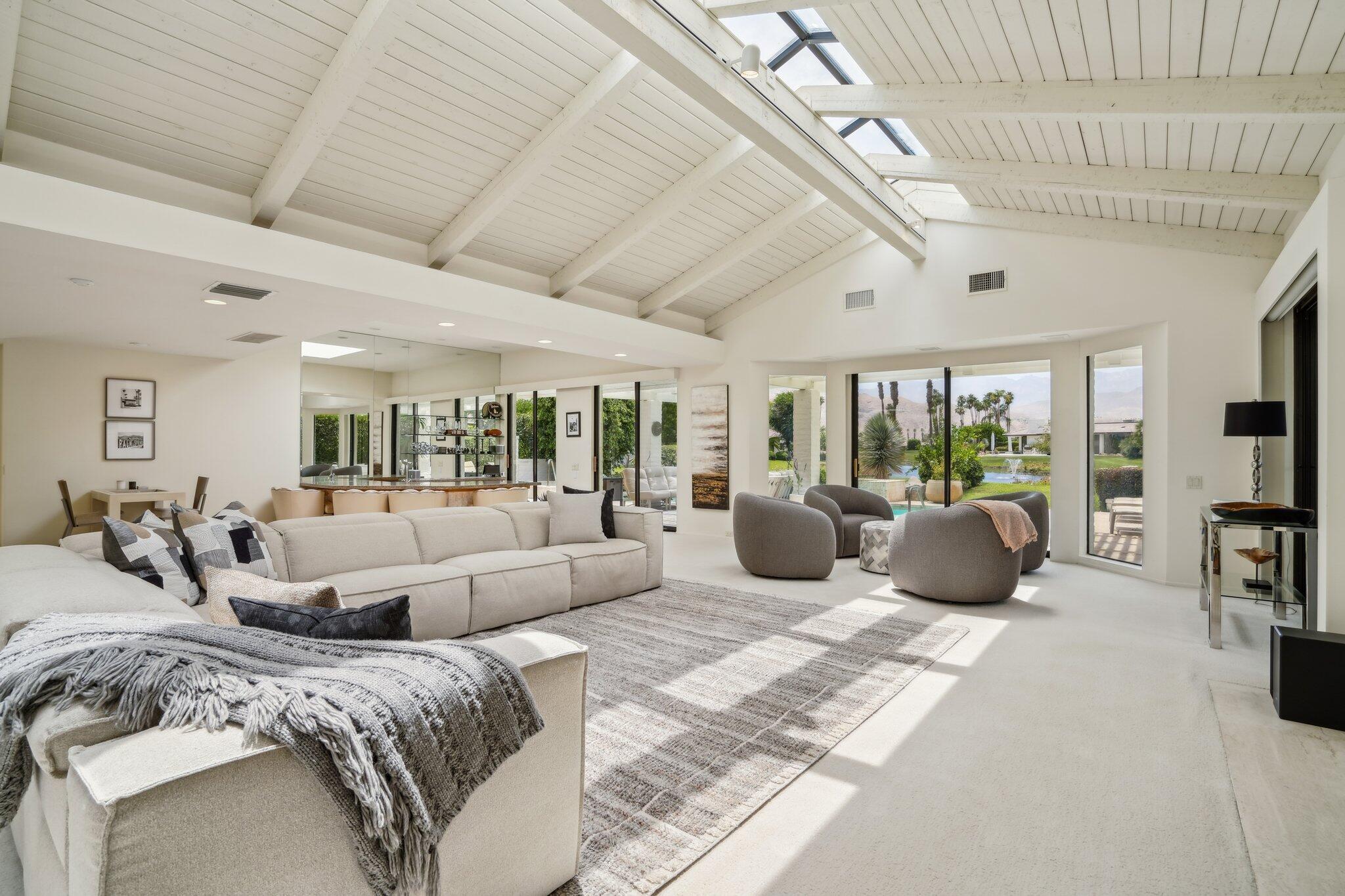 23 Park Lane Rancho Mirage, CA 92270 - Photo 2 of 57 a large bedroom with bed couches chair with outer view