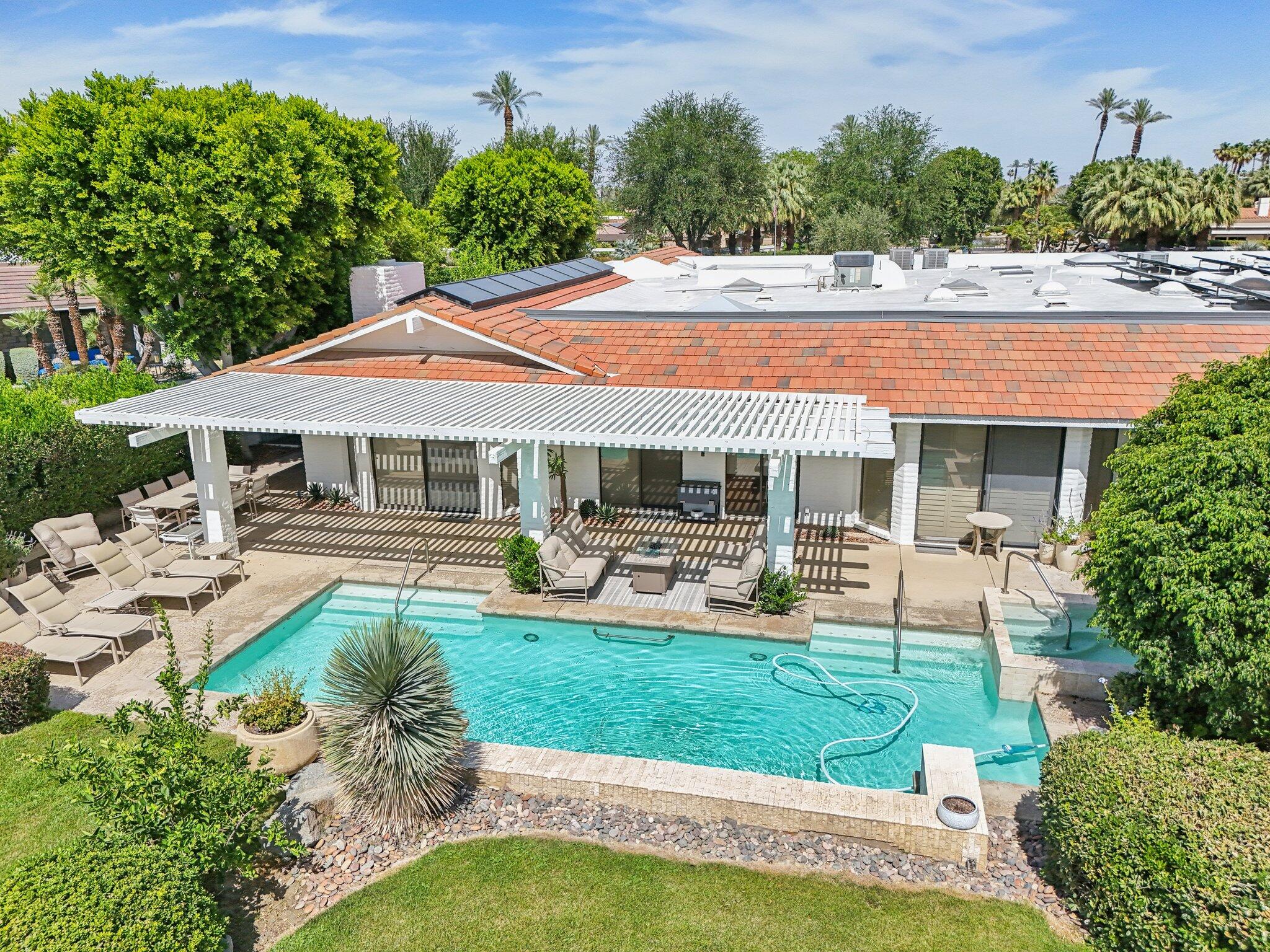 23 Park Lane Rancho Mirage, CA 92270 - Photo 22 of 57 a front view of a house with swimming pool having outdoor seating