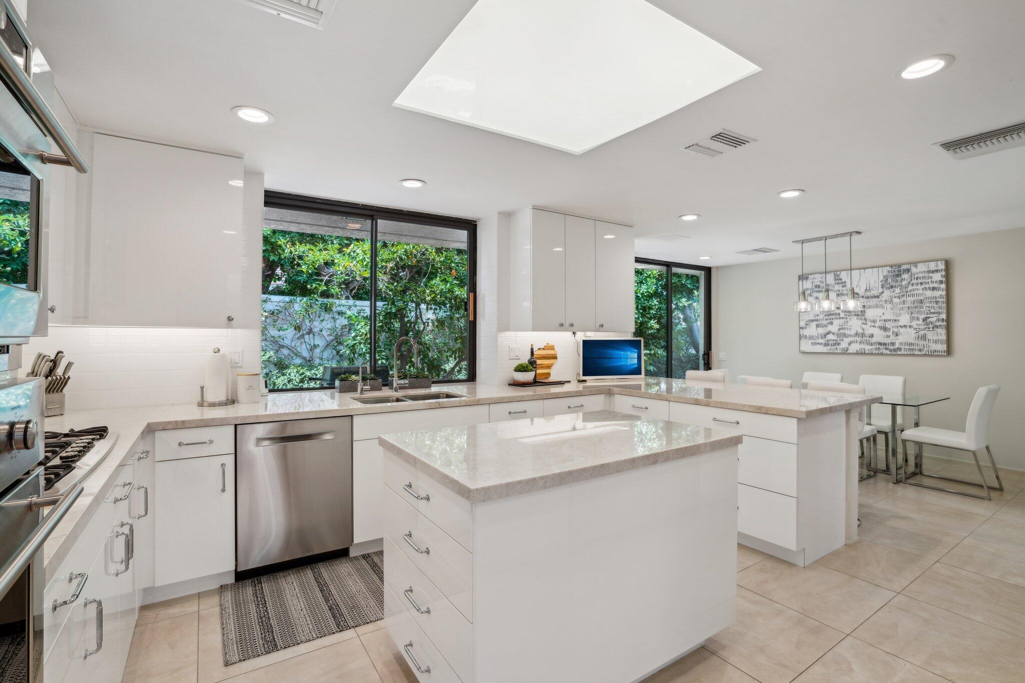 23 Park Lane Rancho Mirage, CA 92270 - Photo 23 of 57 a kitchen with sink cabinets and wooden floor