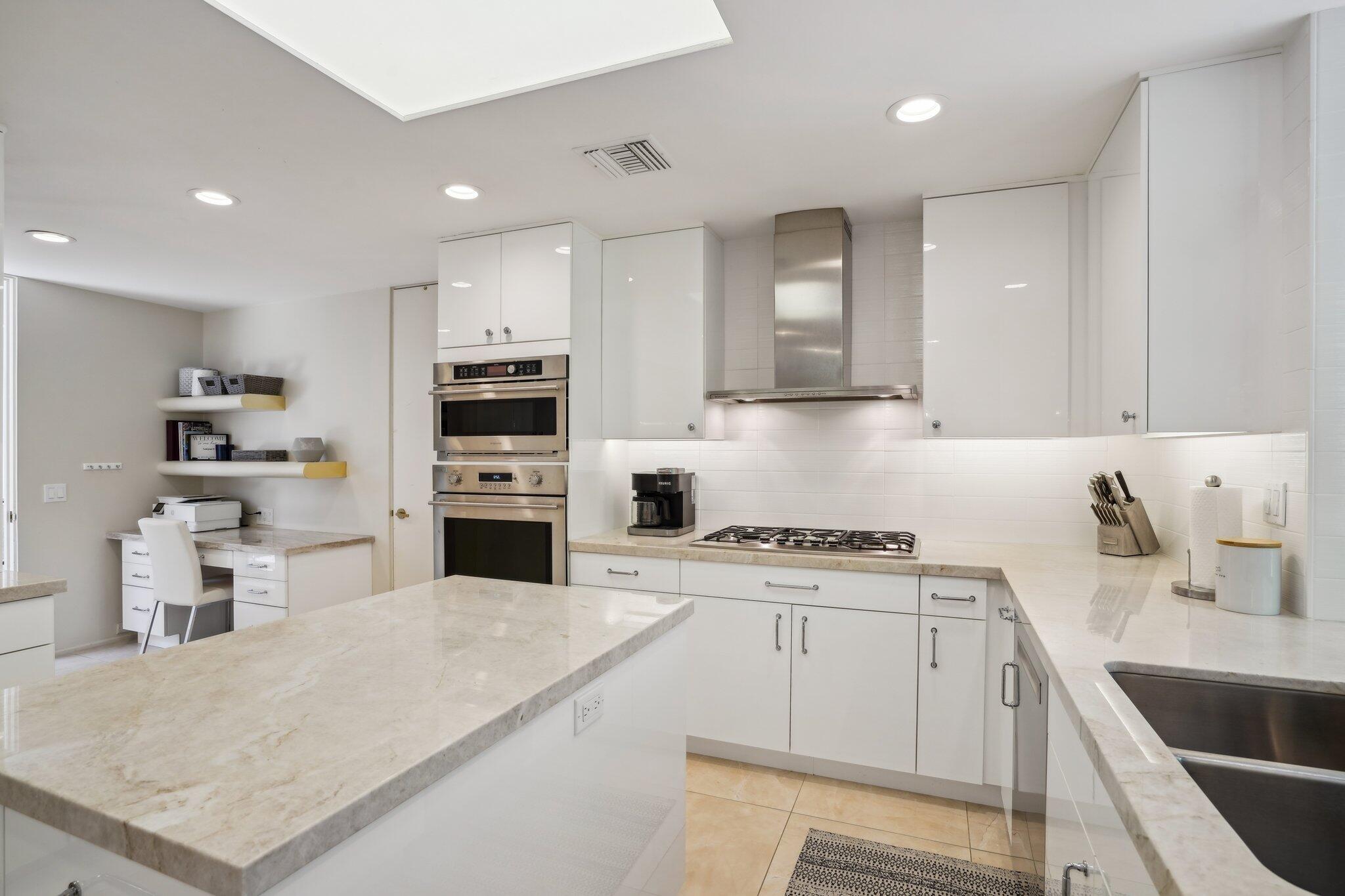 23 Park Lane Rancho Mirage, CA 92270 - Photo 26 of 57 a kitchen with a stove a sink and a refrigerator