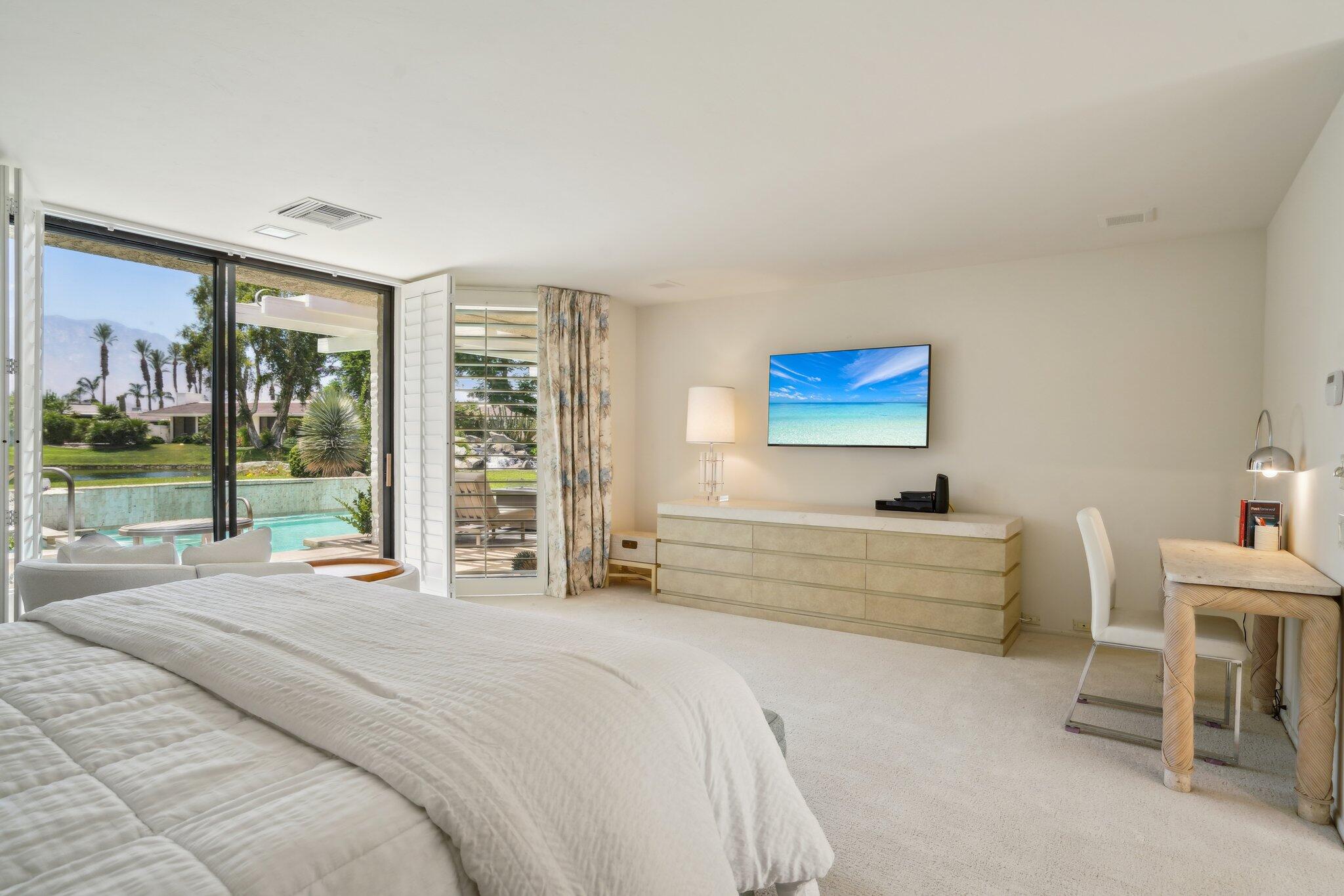 23 Park Lane Rancho Mirage, CA 92270 - Photo 32 of 57 a spacious bedroom with a bed and a large window