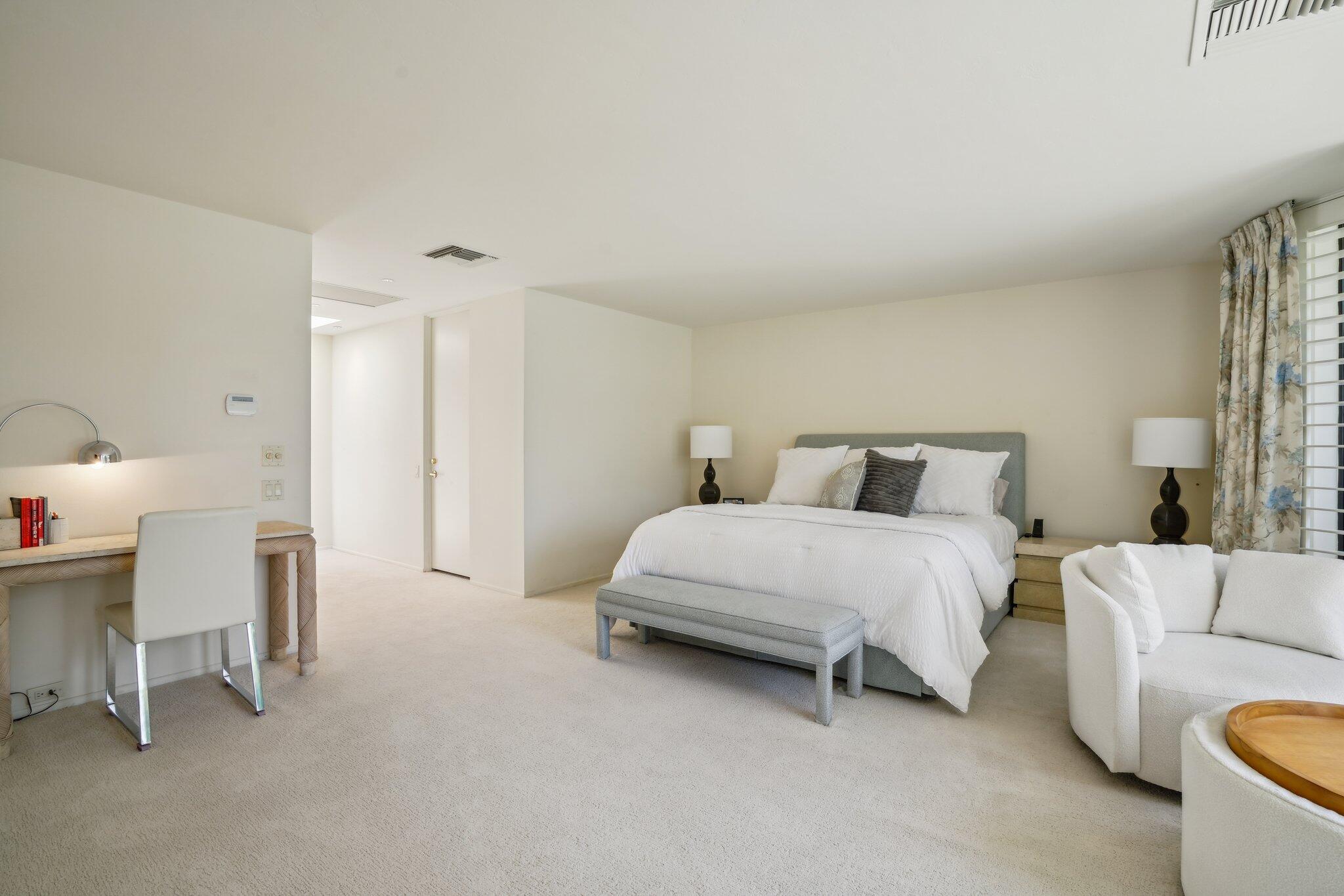 23 Park Lane Rancho Mirage, CA 92270 - Photo 34 of 57 a bedroom with a bed and a chair