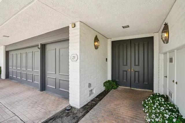 a living room with furniture and a view of kitchen