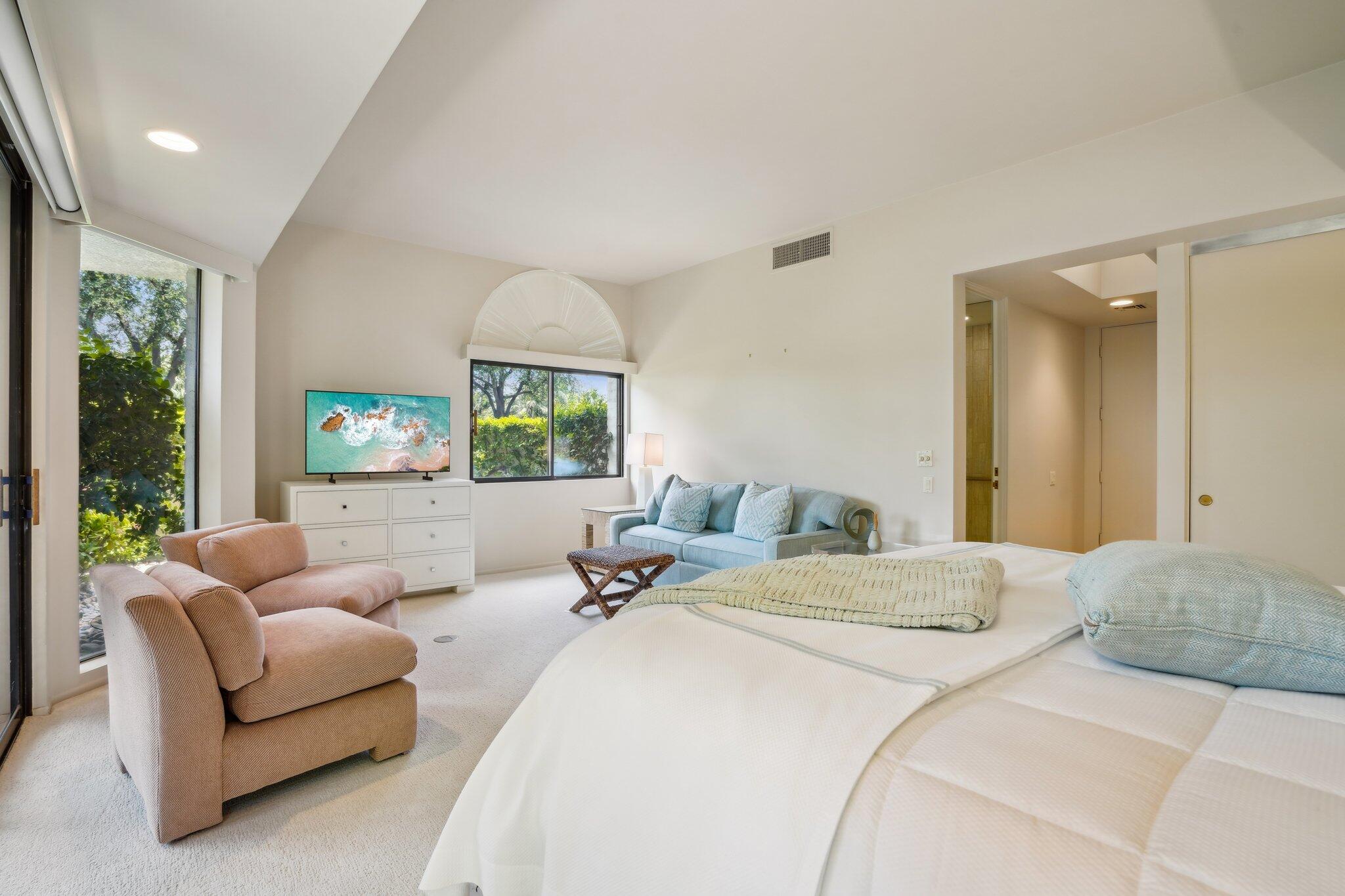 23 Park Lane Rancho Mirage, CA 92270 - Photo 51 of 57 a bedroom with a balcony a bed couch and a window