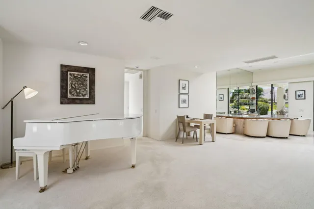 a view of a patio with dining table and chairs with a couches near a garden