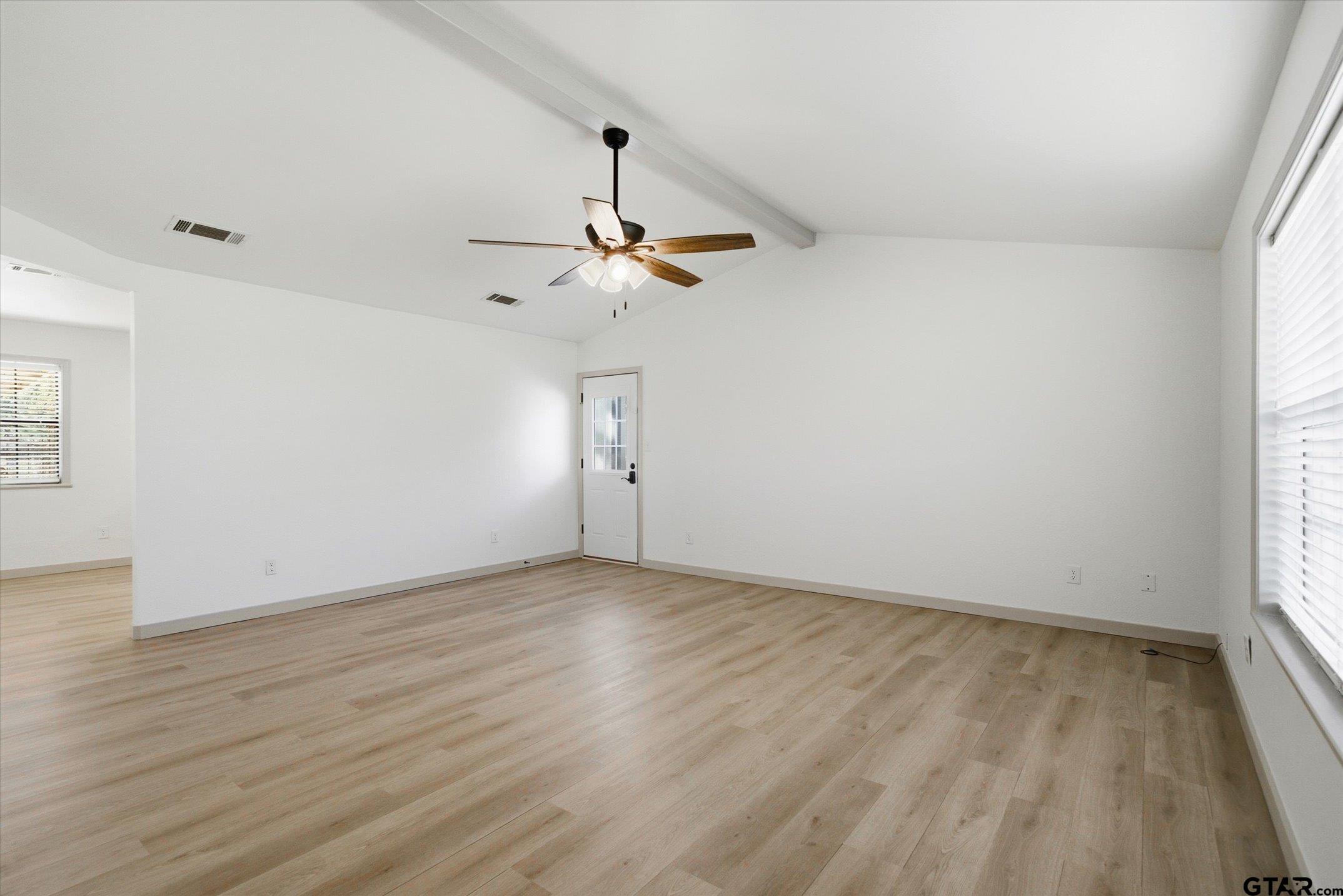 3360 Fm 1805 Van, TX 75790 - Photo 14 of 46 an empty room with wooden floor ceiling fan and window