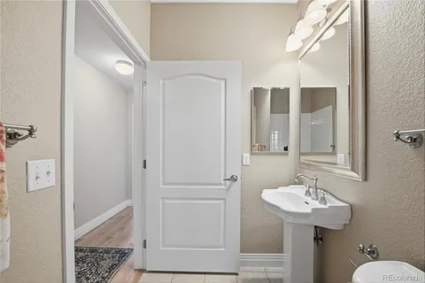a bath tub sitting next to a white toilet and vanity