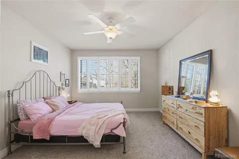 a bedroom with a bed and a mirror