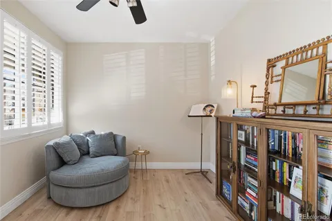 a living room with furniture a rug and a book shelf