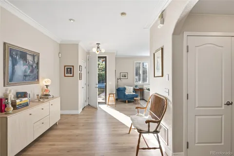 a view of a workspace with furniture and wooden floor