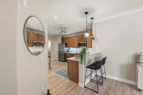 a living room with furniture a window and kitchen view