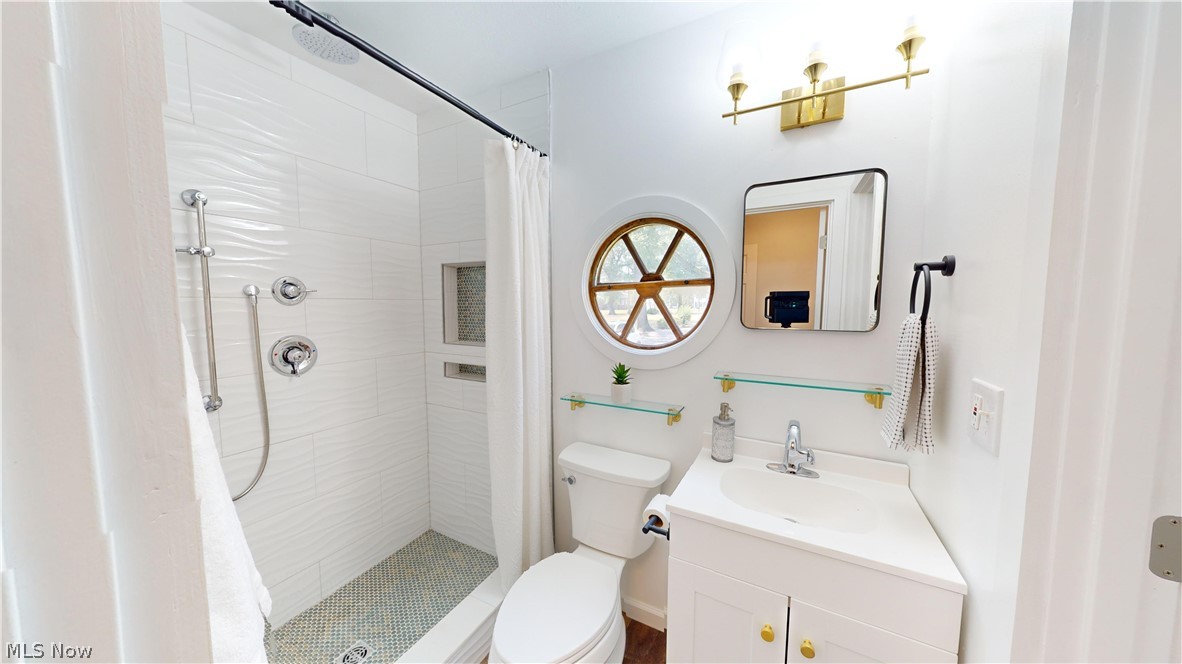 3075 Ludlow Road Cleveland, OH 44120 - Photo 13 of 30 1stfloor full Bathroom with a shower with curtain, vanity, and toilet