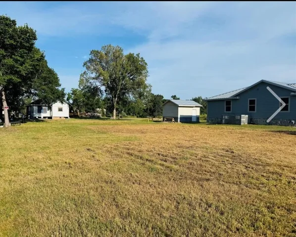 a house view with swimming pool in front of trees