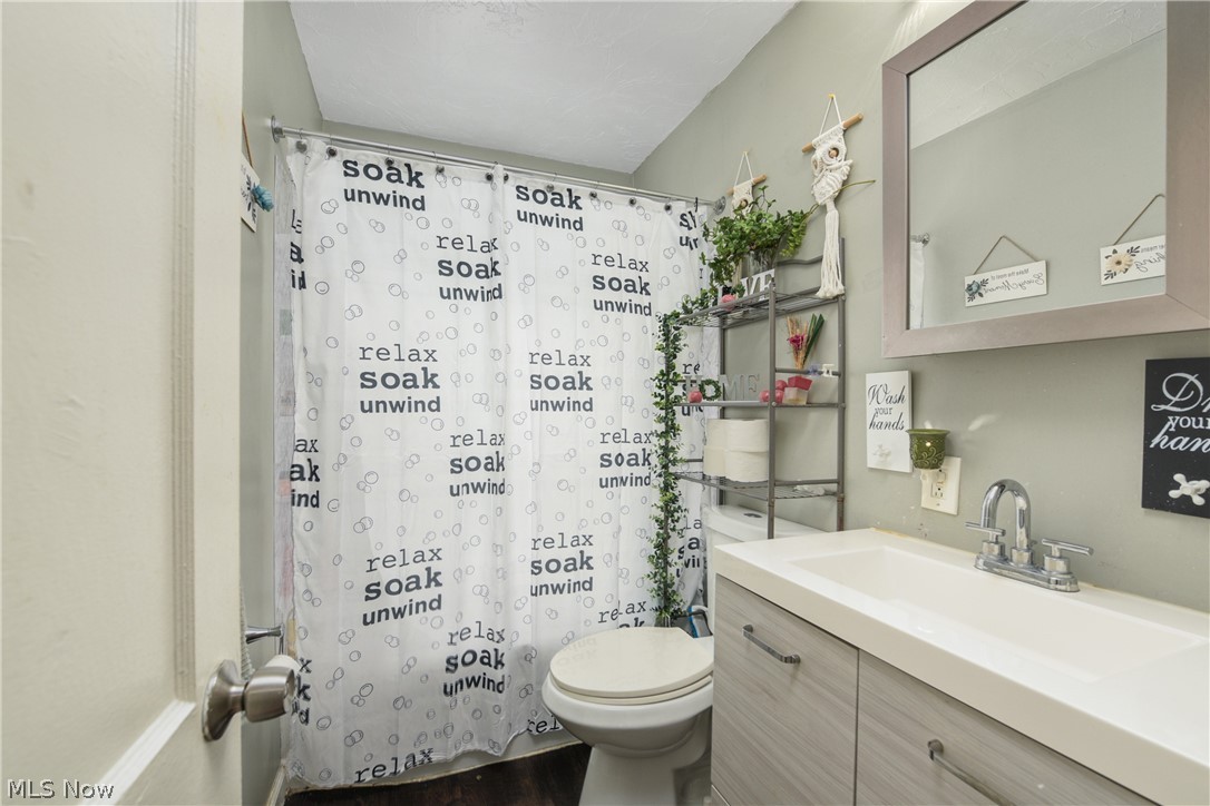 3735 Highland Road Cleveland, OH 44111 - Photo 20 of 35 Bathroom with hardwood / wood-style floors, vanity, and toilet