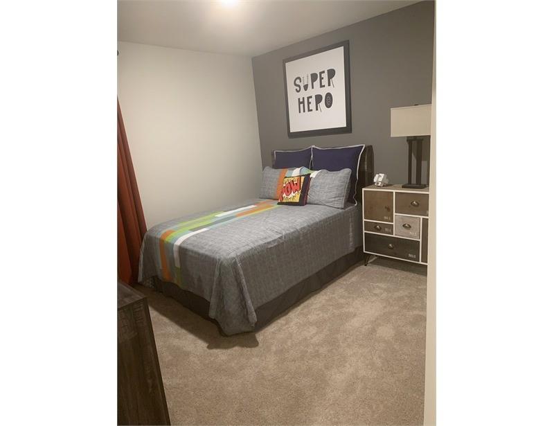 2226 Nightgrove Circle Crandall, TX 75114 - Photo 12 of 19 a bedroom with a bed and a table