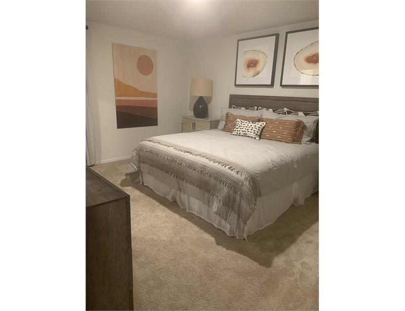 2226 Nightgrove Circle Crandall, TX 75114 - Photo 15 of 19 a bedroom with a bed and a painting on the wall