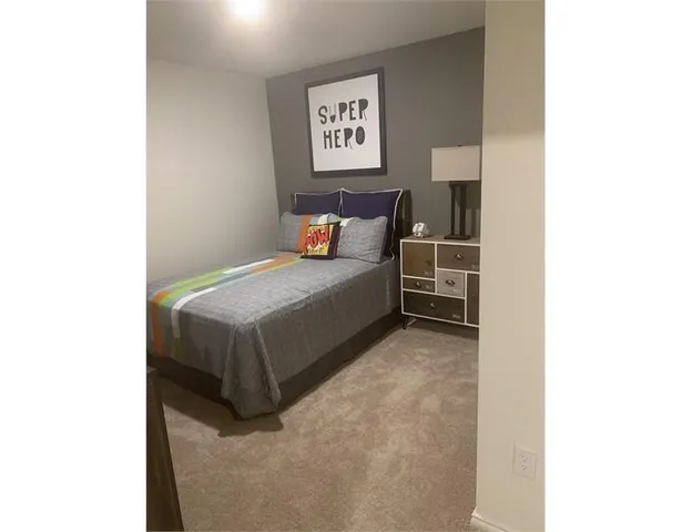 a bed room with a bed and a wall painting