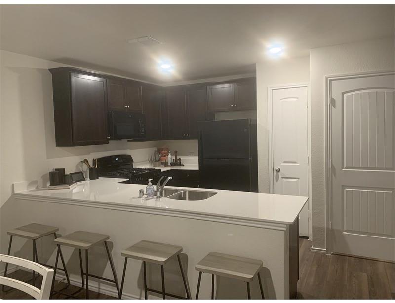 2226 Nightgrove Circle Crandall, TX 75114 - Photo 19 of 19 a room with a sink a refrigerator and cabinets