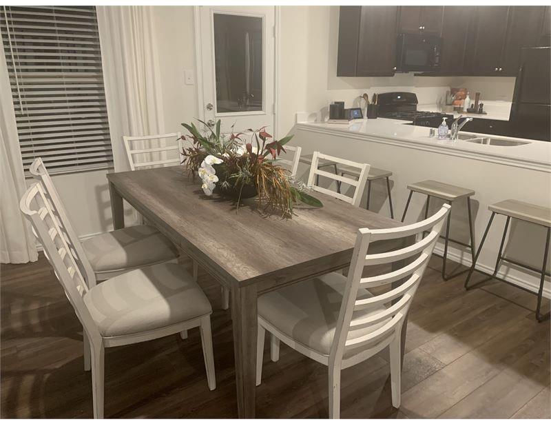 2226 Nightgrove Circle Crandall, TX 75114 - Photo 7 of 19 a kitchen with a dining table chairs and white stainless steel appliances