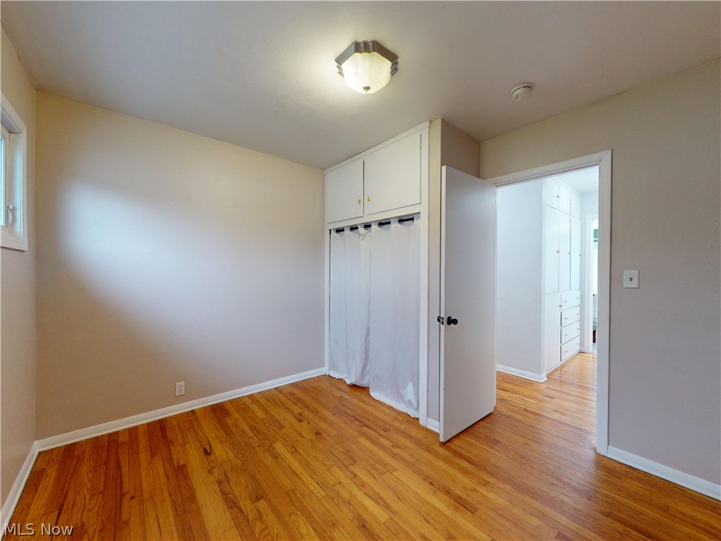 162 South Leavitt Road Amherst, OH 44001 - Photo 20 of 41 Unfurnished bedroom featuring light wood-style floors and a closet