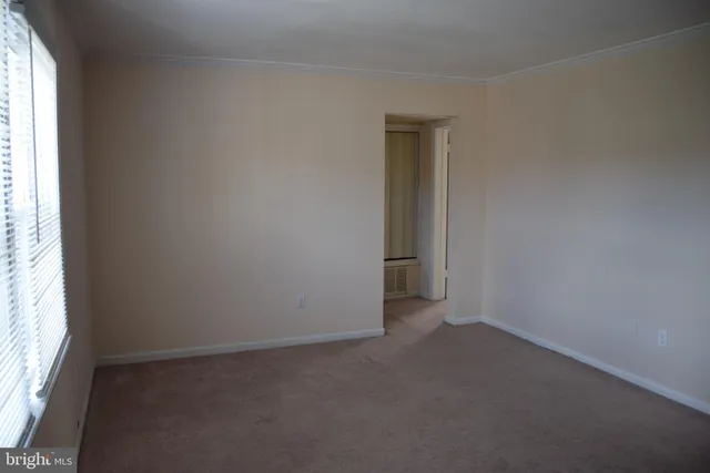 an empty room with a empty space and a window