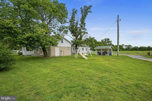 a house with huge green field in front of it