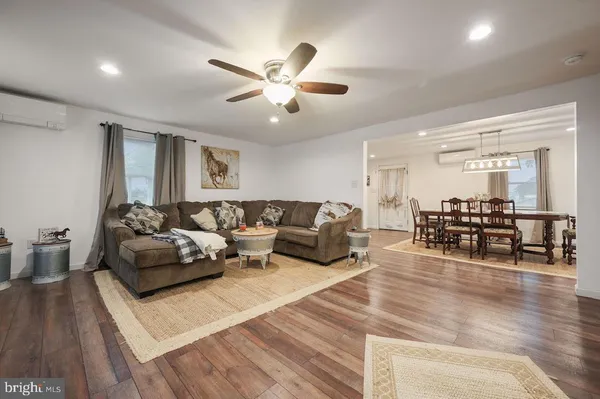 a living room with furniture fireplace and flat screen tv