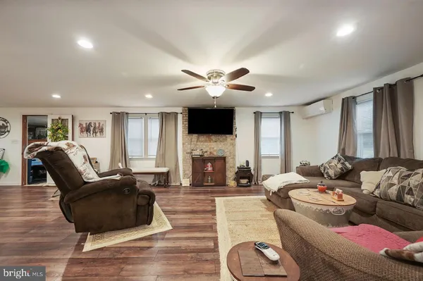 a kitchen with stainless steel appliances kitchen island granite countertop a stove a sink and a refrigerator