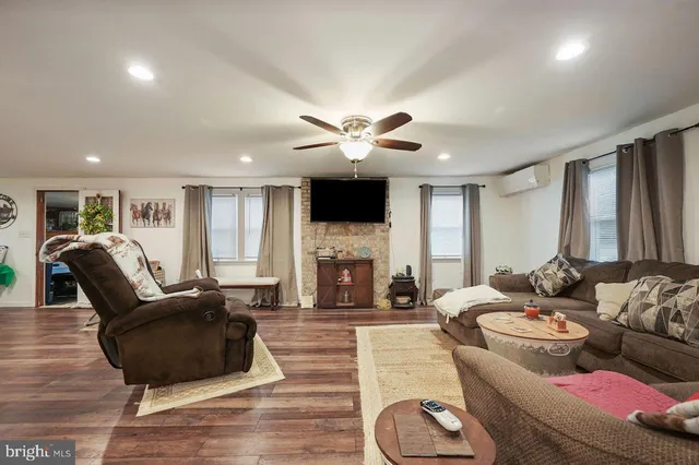 a kitchen with stainless steel appliances kitchen island granite countertop a stove a sink and a refrigerator