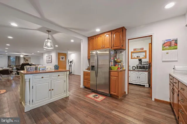 a kitchen with stainless steel appliances granite countertop wooden cabinets a stove a sink and a window
