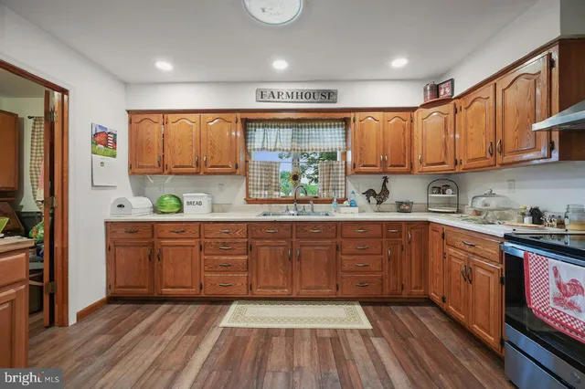 a view of a room with furniture and wooden floor