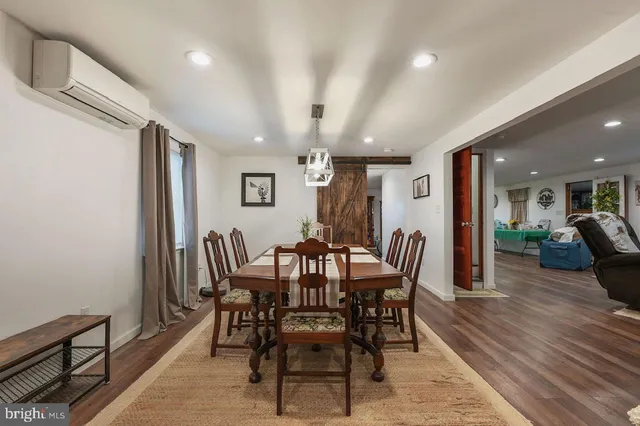 a view of a room with wooden floor and furniture