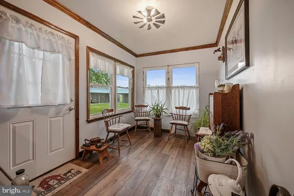 a view of a kitchen with fridge and wooden floor