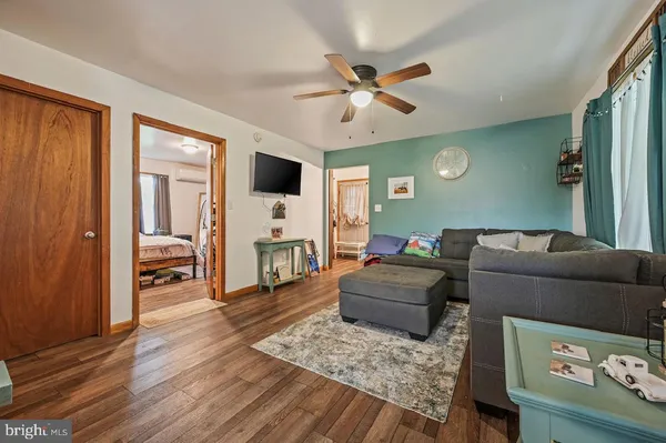 a kitchen with stainless steel appliances granite countertop a stove a sink dishwasher and a refrigerator with wooden floor